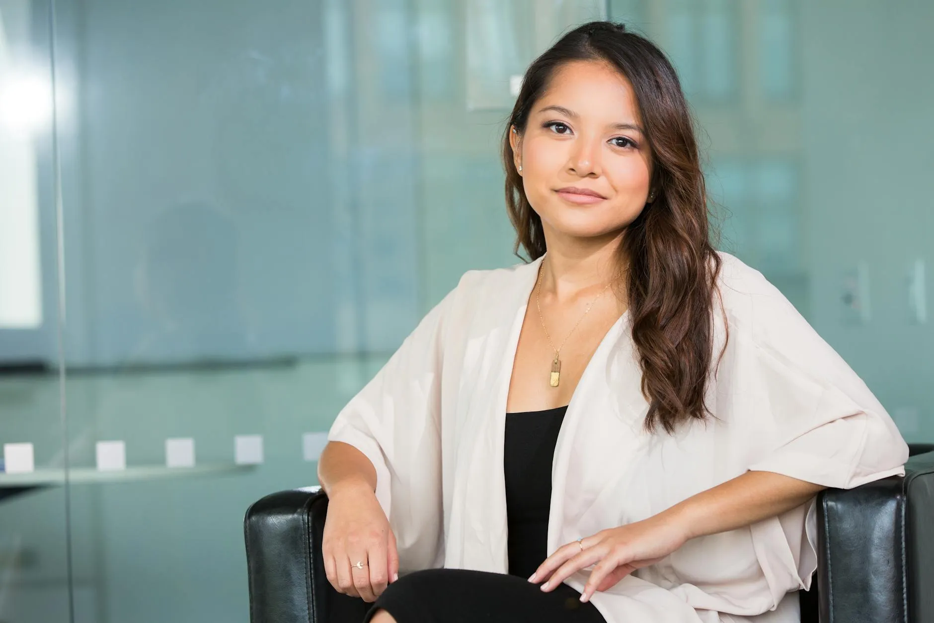 Woman sitting confidently in an office chair.